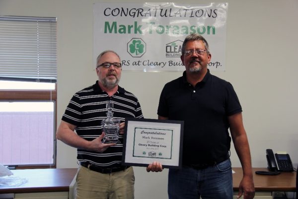 Mark Toraason holds custom decanter while Karl Lemmenes holds anniversary certificate.