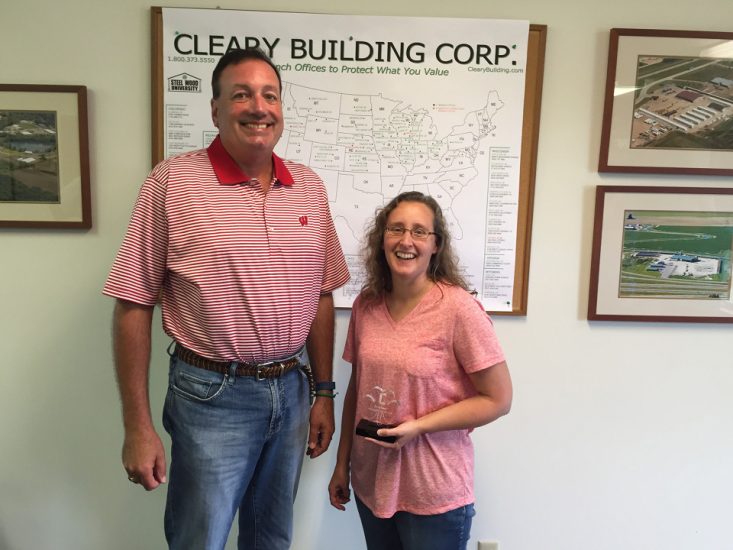 Michelle and Sean stand in front of Cleary Building Corp. map.