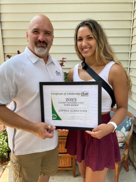 Sophia and her dad, Mat Schneider, holding the scholarship certificate.
