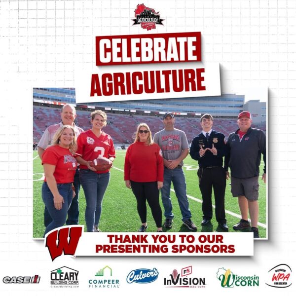 Seven people stand on the field at Camp Randall Stadium in support of agriculture.