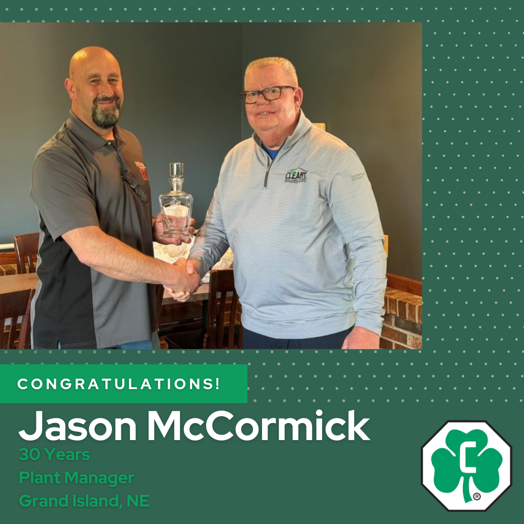Jason McCormick (left) is presented with a 25-year anniversary certificate and custom Cleary decanter by Tim Johnson (right)